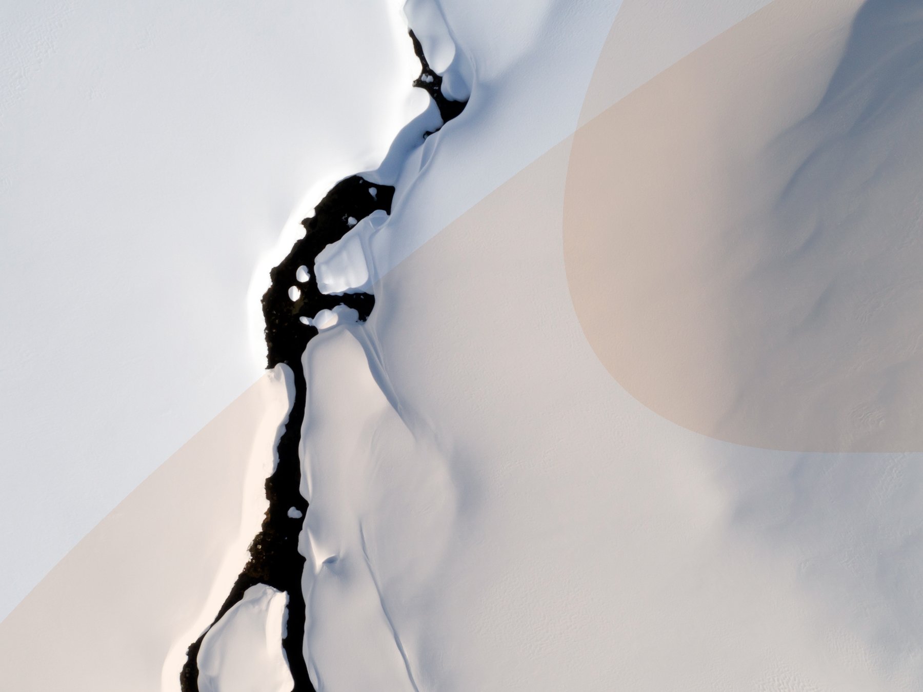 Aerial view of an abstract natural pattern in a winter landscape with a mountain stream in the Swiss Alps.