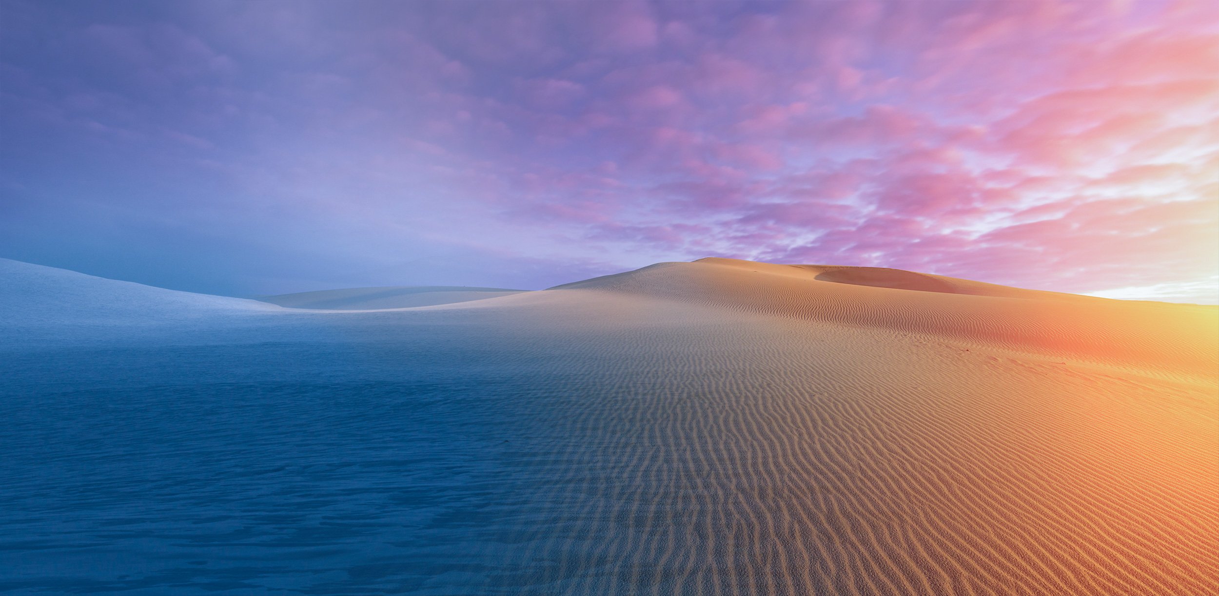 Ambient image blend of snowy mountains to the left, blending into sand dunes on the right.